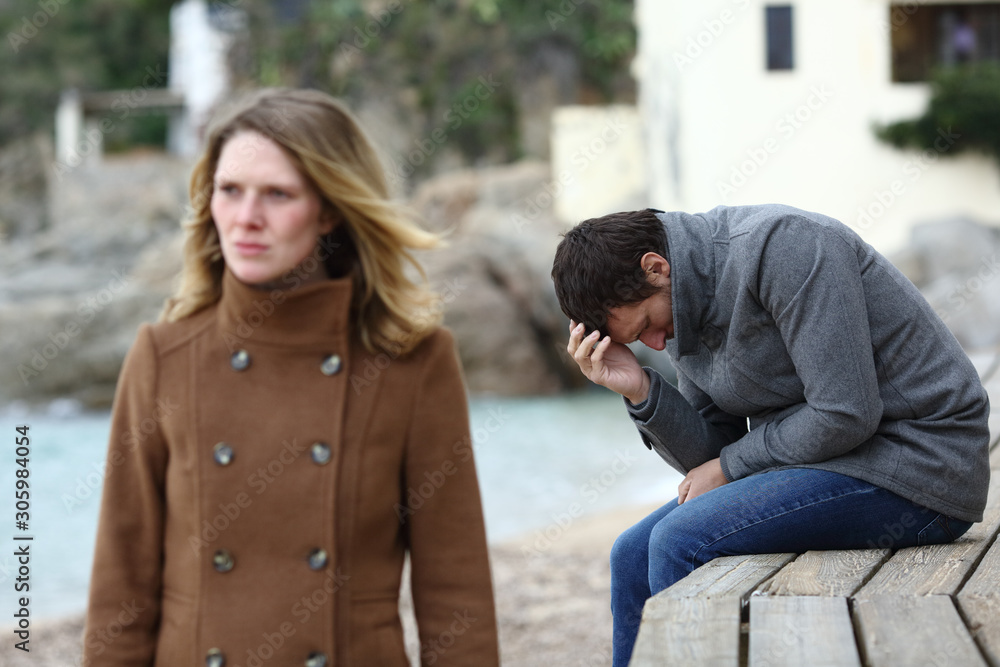 Fototapeta premium Sad husband complaining after break up in winter