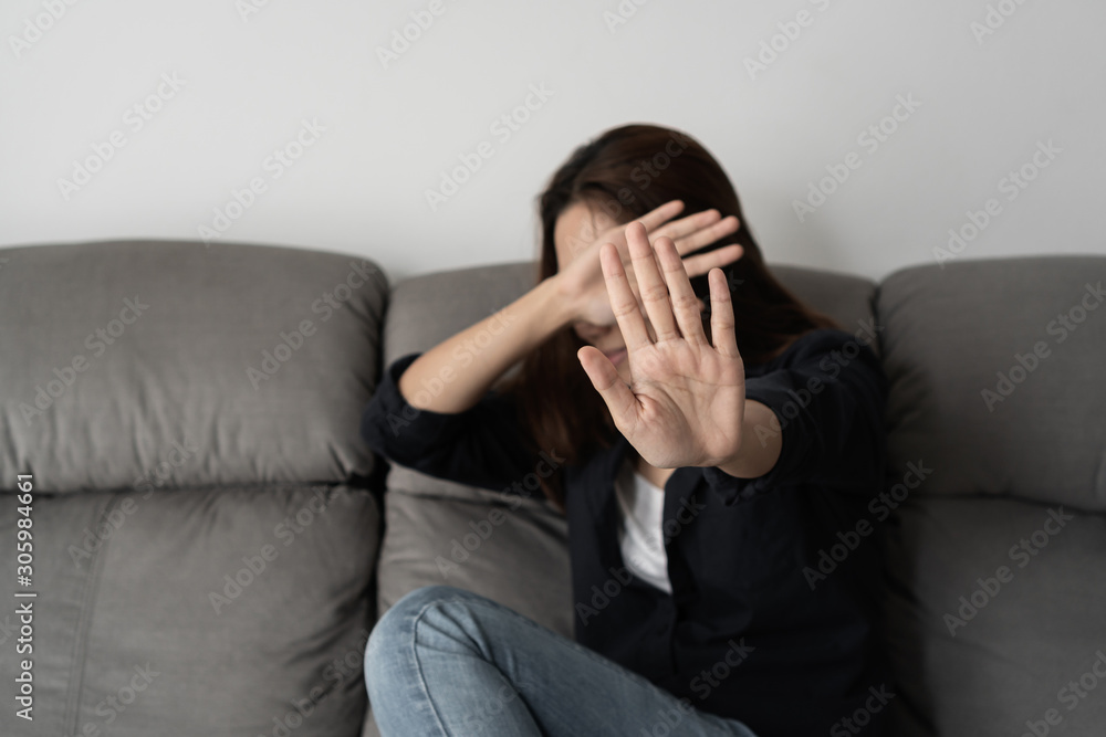 Woman covering her face in fear of domestic violence, concept violence and abuse. Woman covering her face in fear of domestic violence, concept violence and abuse.