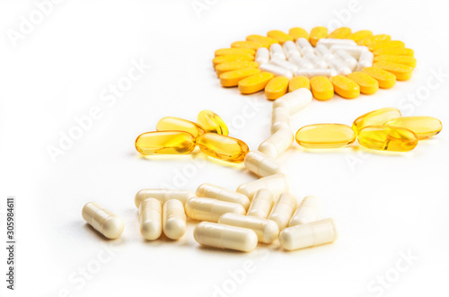 Group of vitamin pills - flower formed on white background - selective focus