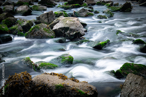 Long exposure of River Meavy water flowing over rocks at Lopwell Weir, Plymouth, Devon photo