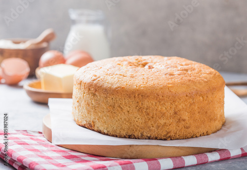 Fototapeta Homemade  Soft and lite delicious sponge cake with ingredients: eggs flour milk on stone concrete table