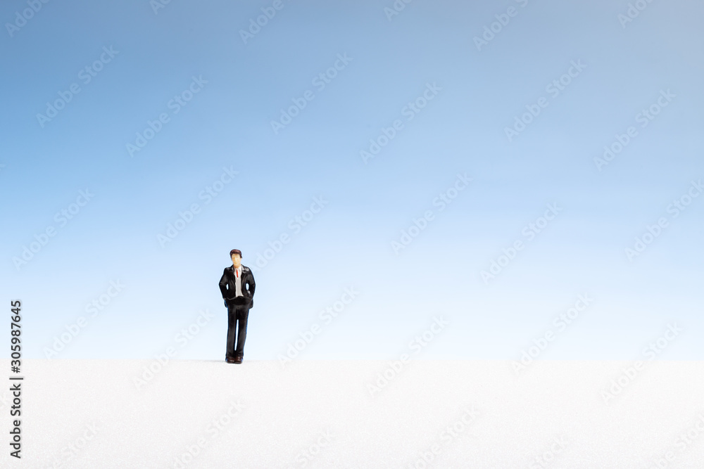 Lonely man concept. Man miniature on abstract space Lonely man concept. Man miniature on abstract space