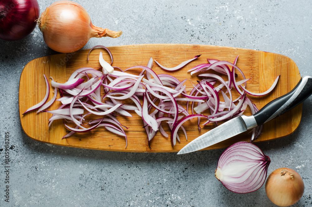 Sliced red onion on wooden chopping Board. Top view