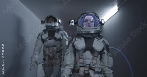 Astronauts walking down a corridor