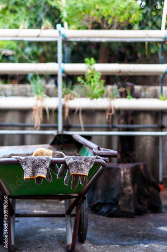 Worker gloves hanging on a cart handle after a hard work.