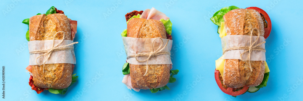 Fototapeta premium Fresh bread sandwich with ham, lettuce and tomato, banner