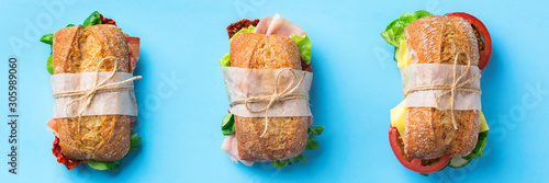 Fresh bread sandwich with ham, lettuce and tomato, banner photo