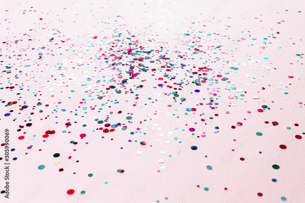 Glitter flying sparkles on pink pastel trendy background. Festive backdrop for graphic design projects.