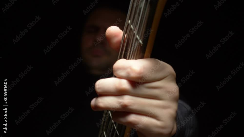 fretboard of electric guitar close-up on a black background. fretboard of electric guitar close-up on a black background.