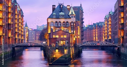 Hamburg, Germany. The Warehouse District (German: Speicherstadt) at dusk. View of Wandrahmsfleet. The largest warehouse district in the world is located in the port of within the HafenCity quarter.