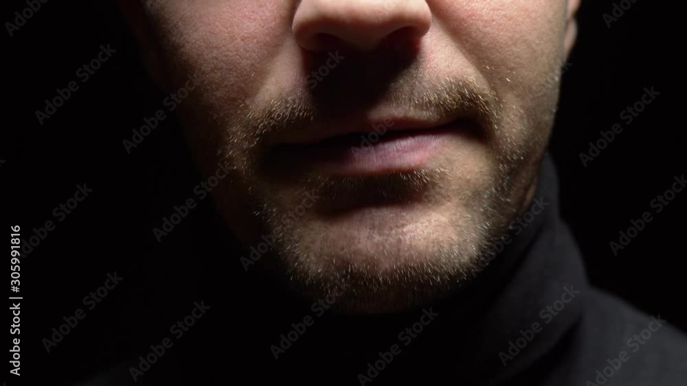closeup. male mouth with crooked teeth screaming. Black background closeup. male mouth with crooked teeth screaming. Black background