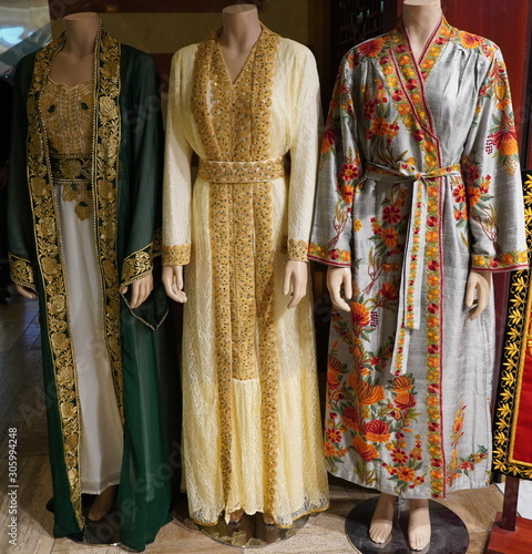 Dubai UAE - November 2019: Arabic Women's Clothes Displayed for Sale at a Boutique Luxury Cloth Store on mannequin. Outside Women and men clothing shop. Traditional muslim women dresses on mannequins.