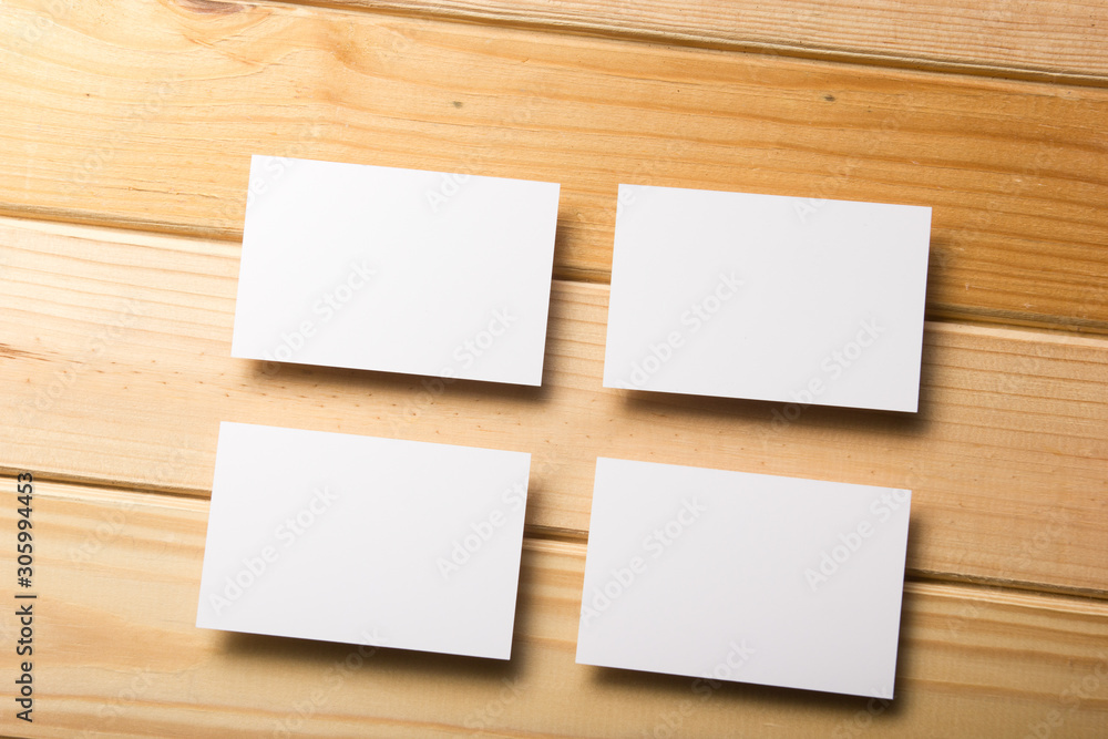 Business card blank on wooden background. Corporate Stationery, Branding Mock-up. Creative designer desk. Flat lay. Copy space for text Business card blank on wooden background. Corporate Stationery, Branding Mock-up. Creative designer desk. Flat lay. Copy space for text