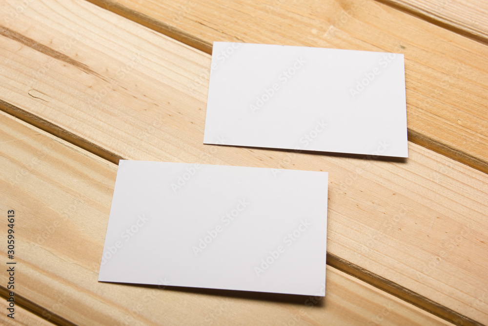 Business card blank on wooden background. Corporate Stationery, Branding Mock-up. Creative designer desk. Flat lay. Copy space for text Business card blank on wooden background. Corporate Stationery, Branding Mock-up. Creative designer desk. Flat lay. Copy space for text