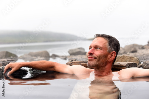 Принти на полотні Man bathing and relaxing in hot springs during summer day