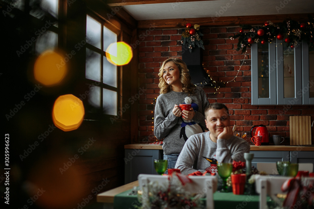 husband and wife drink tea in the kitchen