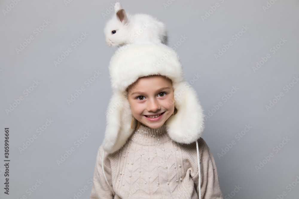 happy little girl with adorable rabbit at christmas time. happy little girl with adorable rabbit at christmas time.