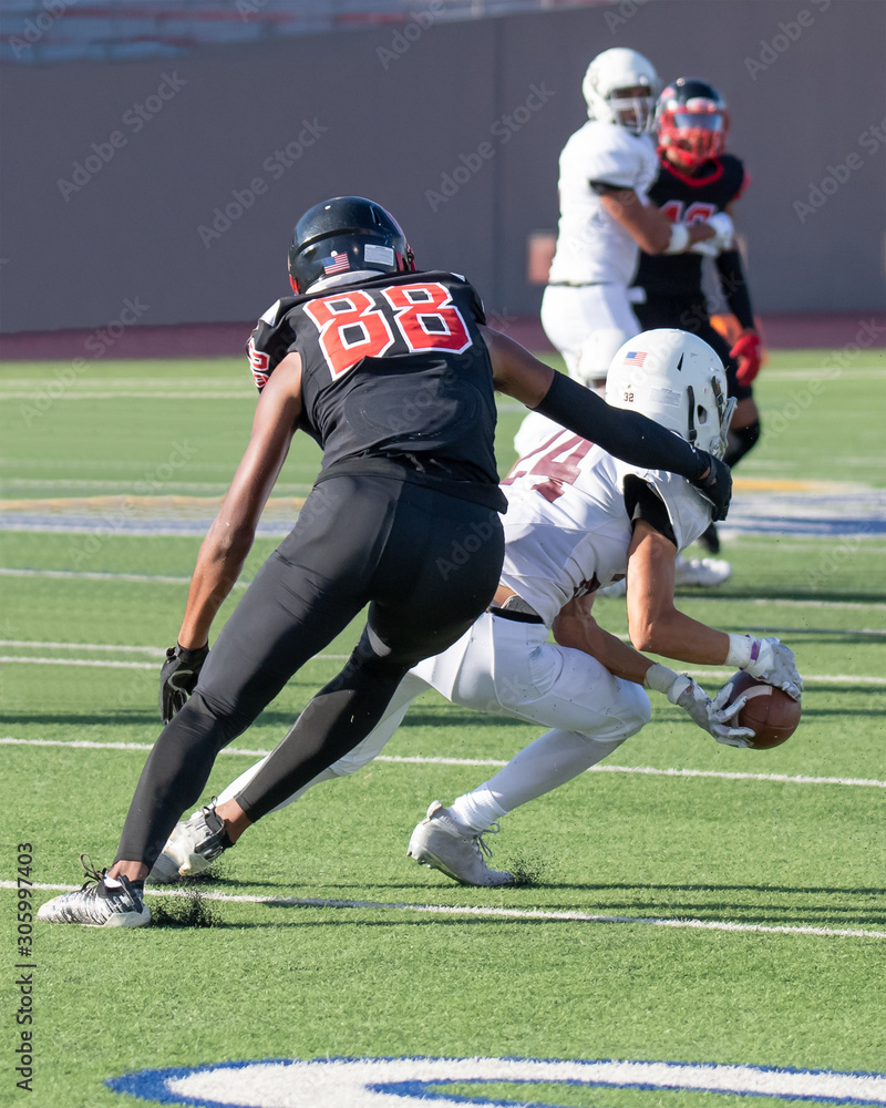 Action photos of high school football players making amazing plays during a football game Action photos of high school football players making amazing plays during a football game