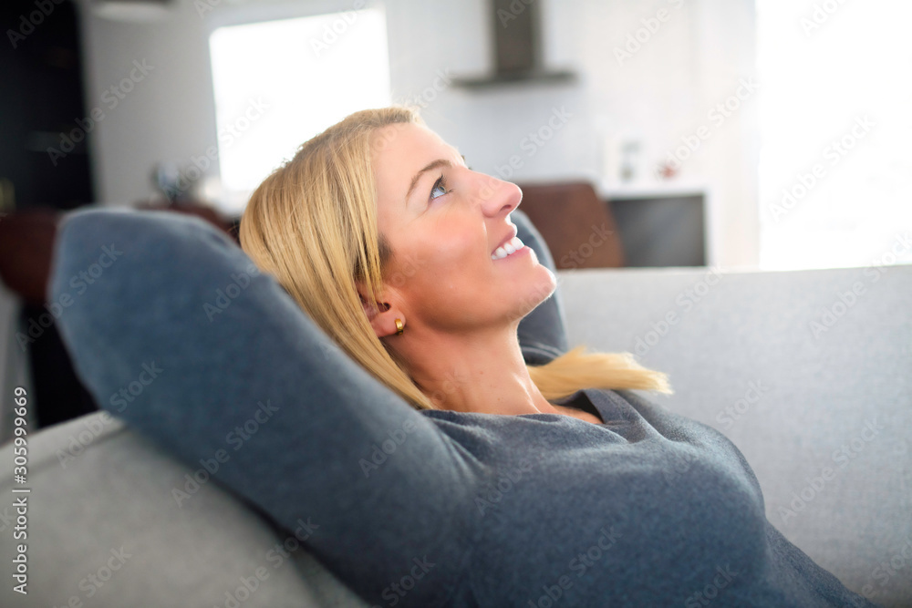 Relaxed young woman enjoying rest on comfortable sofa, calm attractive girl relaxing on couch Relaxed young woman enjoying rest on comfortable sofa, calm attractive girl relaxing on couch