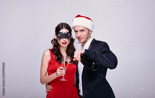 Portrait of embraced couple celebrating New Year at studio shot. photo