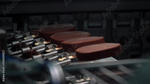 Chocolate Ice-cream production line. Desserts on conveyor belt. Food production process.