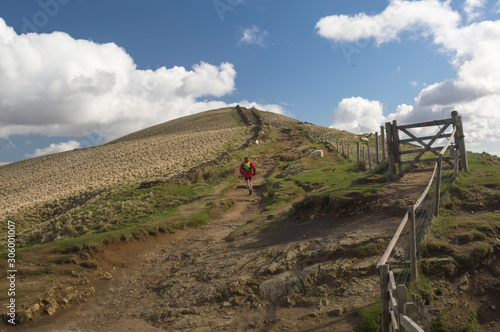 A runner running along the Mam Tor Trail in the Peak District, Derbyshire