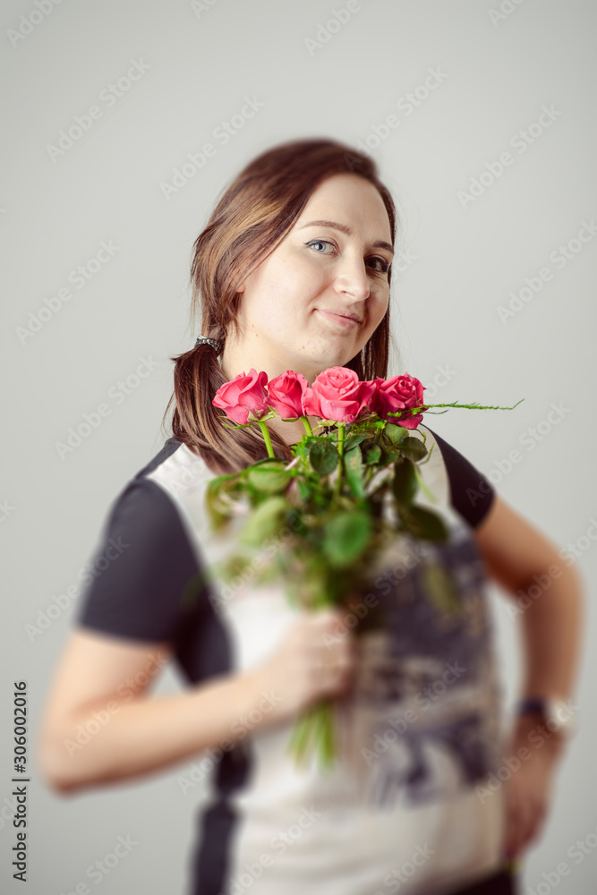 portrait of young charming girl with a bouquet of roses portrait of young charming girl with a bouquet of roses
