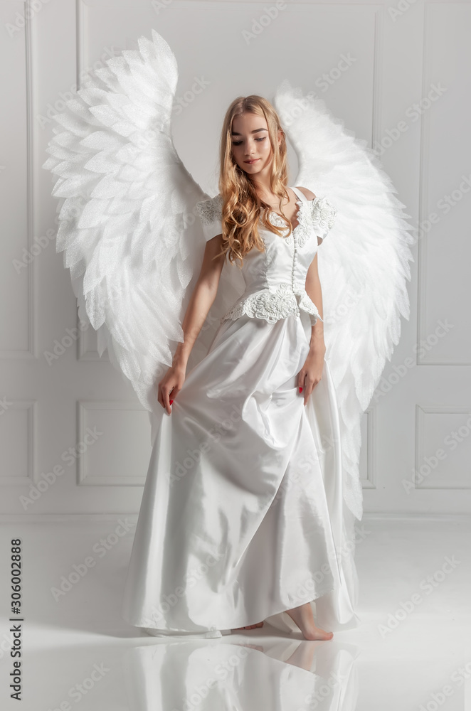 Girl in white dress with angel wings Girl in white dress with angel wings