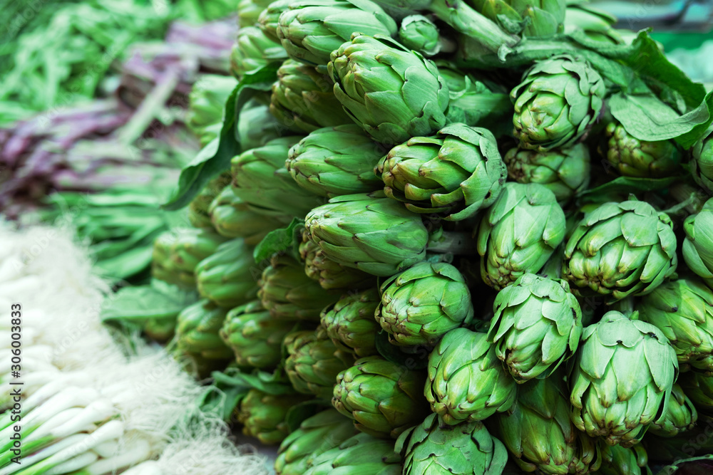 Fototapeta premium Big ripe organic artichokes for sale at local market..