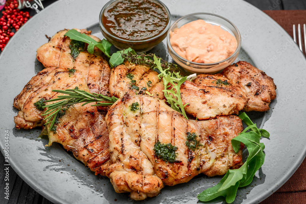 Tasty Grilled chicken fillet and chili peppers on a plate on the table. horizontal view from above