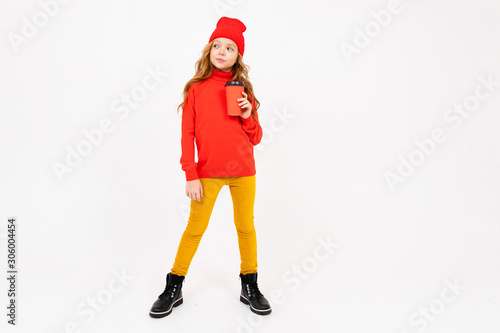 European cute girl in red posing with a glass of coffee in her hands on a white background