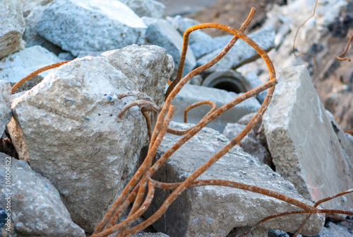 Rusted and twisted steel rebar with concrete slab chunks