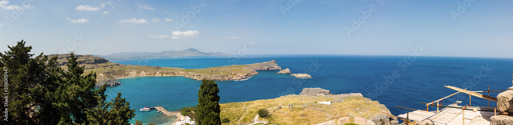 Obraz premium A blue sea and mountains in sunny summer day. St Paul's Bay in Rhodes Greece Europe.