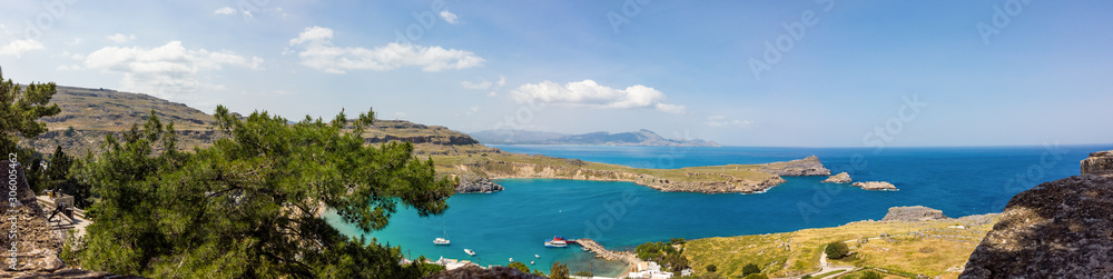A blue sea and mountains in sunny summer day. St Paul's Bay in Rhodes Greece Europe.