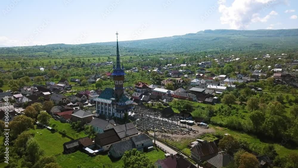 Aerial view of Church in Merry Cemetery, Colored Tombstones with Spiritual and Merry Cemetery in Maramures, Romania, Decorated tombstones in the Merry Cemetery Aerial view of Church in Merry Cemetery, Colored Tombstones with Spiritual and Merry Cemetery in Maramures, Romania, Decorated tombstones in the Merry Cemetery
