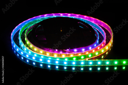 RGB LED strip on reel with black background.