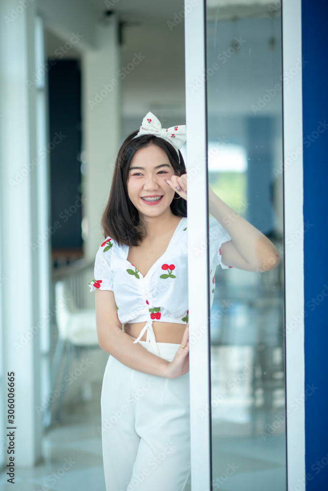A young Asian woman is cute, bright, and she smiles happily on a holiday.