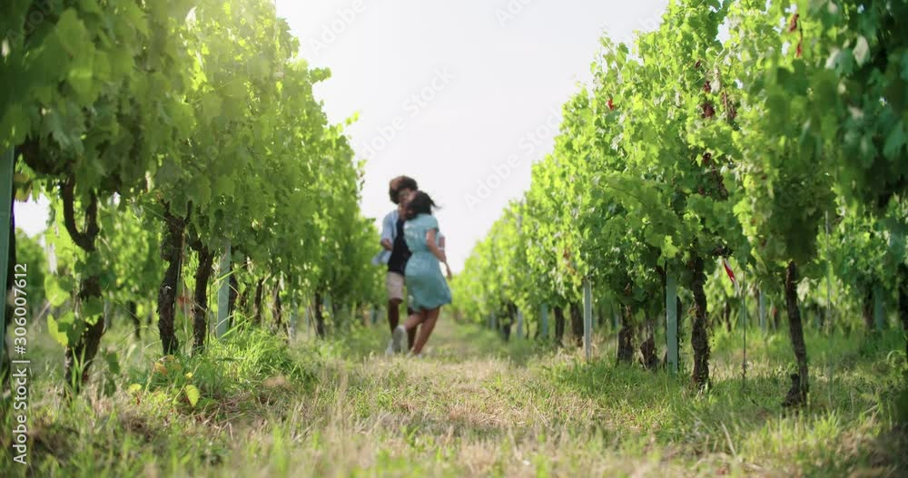 Romantic love couple walking and playful running thru green vineyards. Front follow wide shot.Friends italian trip in Umbria.4k slow motion Romantic love couple walking and playful running thru green vineyards. Front follow wide shot.Friends italian trip in Umbria.4k slow motion
