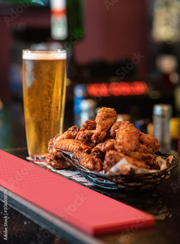 An image of beer and chicken wings