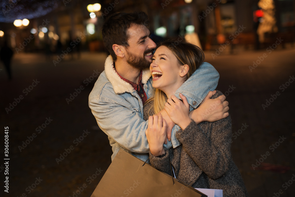 Young couple outside with shopping bags Young couple outside with shopping bags