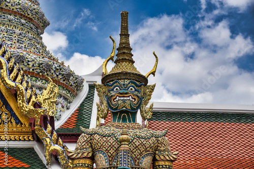Giant Yak, Yaksha statue with large teeth, piercing eye with sword in hand protecting and guarding the famous Temple of the Emerald Buddha or Wat Phra Kaew from evil spirits