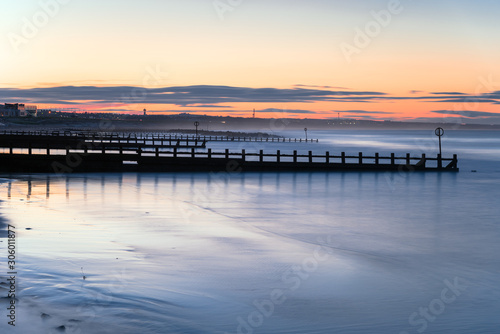 Long exposure of beach with groynes at twilight. Aberdeen, Scotland, UK. © alpegor