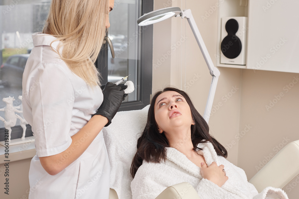 Female beautician makes injection of vitamins and minerals in the scalp. The concept of hair loss. Female beautician makes injection of vitamins and minerals in the scalp. The concept of hair loss.