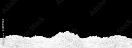 Pile of fluffy white snow isolated on pure black background