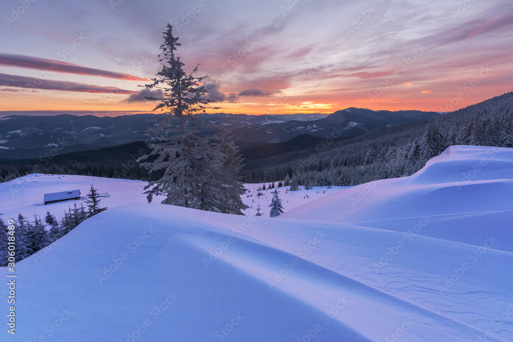 Colorful winter dawn on the mountain valleys in the Ukrainian Carpathian Mountains.	