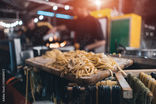 traditional italian black and yellow raw pasta on food festival