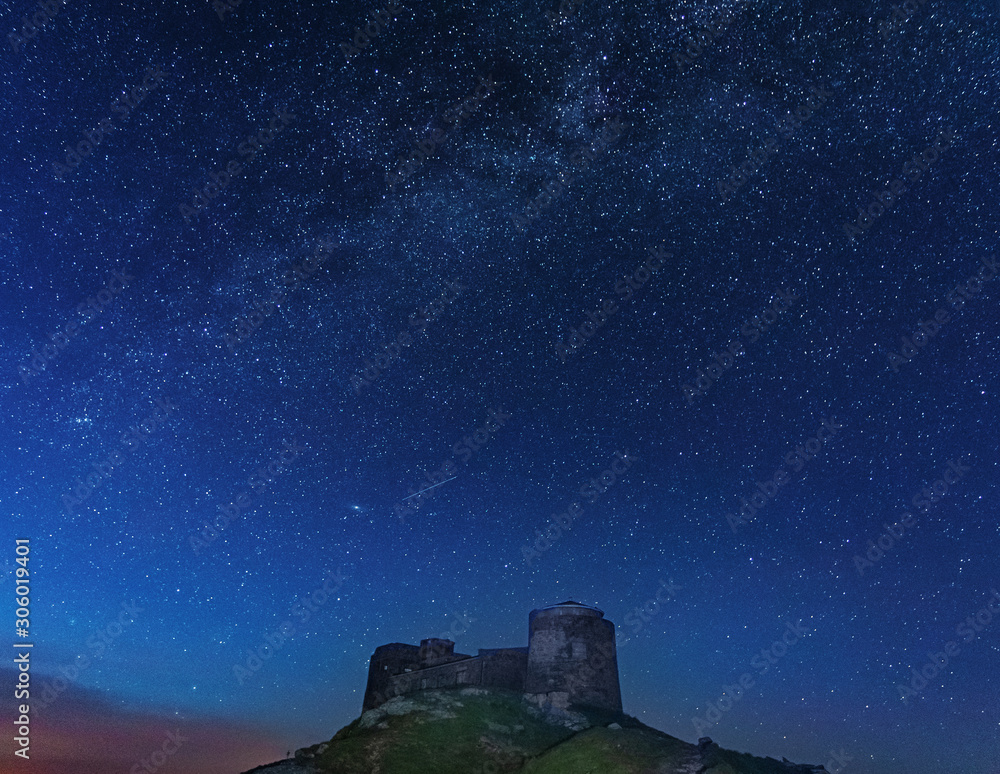 Warm summer season in the Ukrainian Carpathians overlooking the observatory atop a mountain with a night sky and the Milky Way