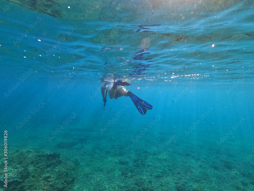 Underwater photo of spear fishing gun scuba diver in tropical exotic sea