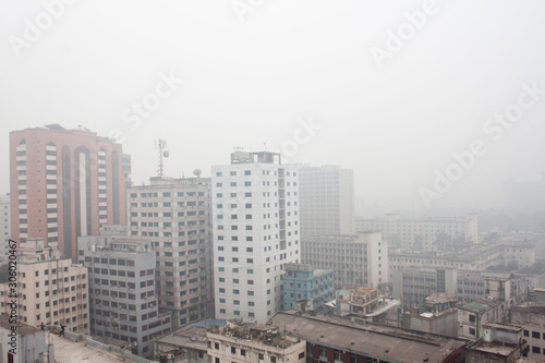 Bangladesh – January 06, 2014: This is winter afternoon aerial views of dhaka city. Heavy foggy winter cross of the city of Dhaka.