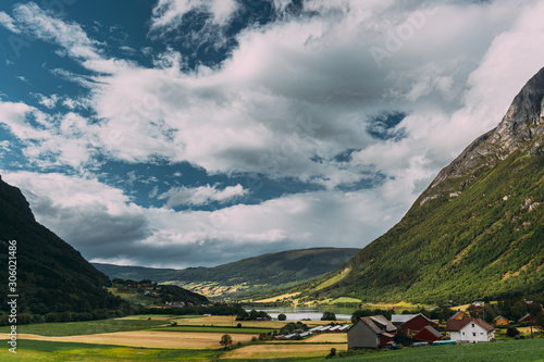 Byrkjelo Village, Sogn Og Fjordane County, Norway. Beautiful Sky Above Norwegian Rural Landscape. Bergheimsvatnet Lake In Summer Day. Agricultural And Weather Forecast Concept photo